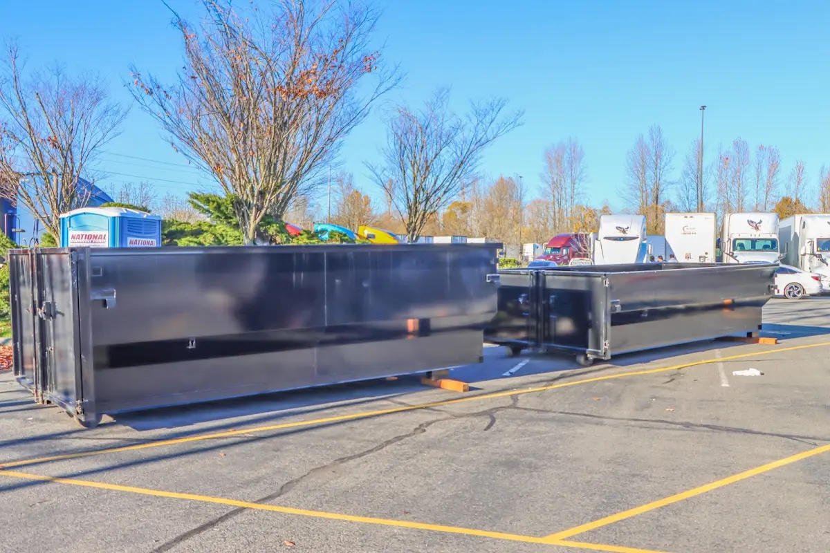 Professional dumpster rental service with roll-off container on residential driveway in Palm Harbor